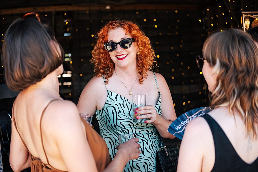Multi coloured Summer wedding with a bride wearing green at The Barns at Lodge Farm. Essex documentary wedding photographer