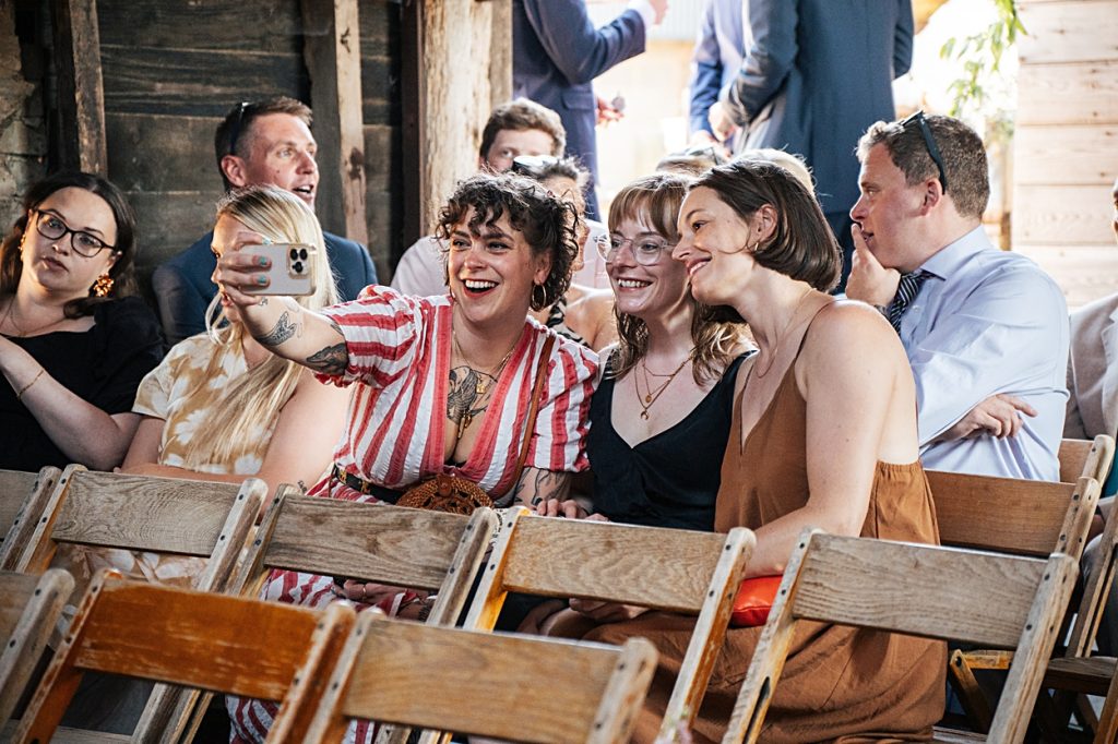 Multi coloured Summer wedding with a bride wearing green at The Barns at Lodge Farm. Essex documentary wedding photographer