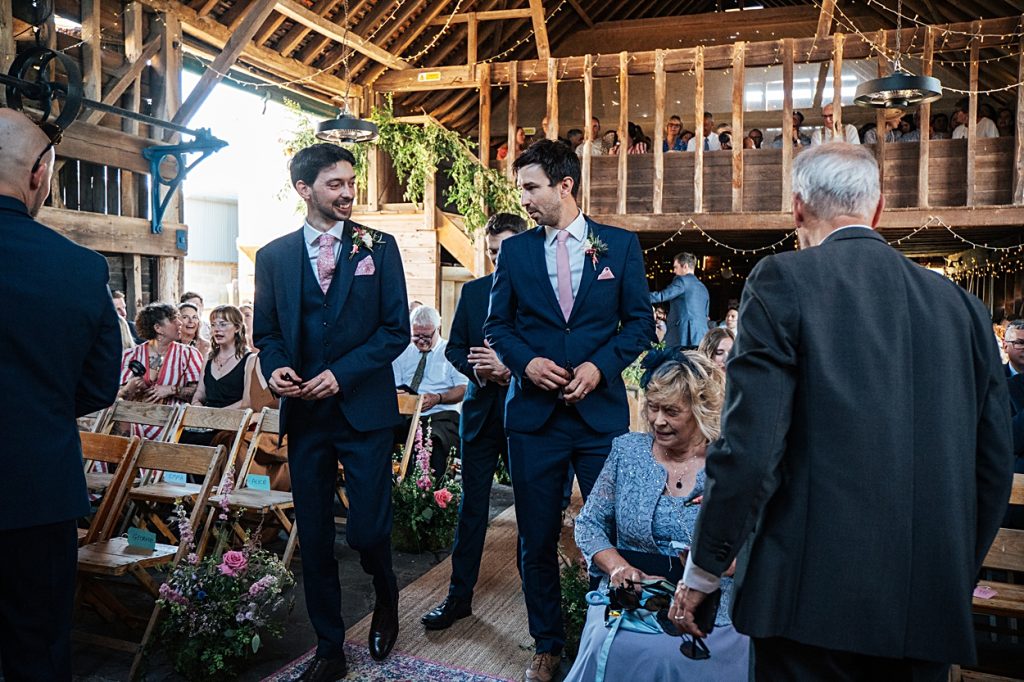 Multi coloured Summer wedding with a bride wearing green at The Barns at Lodge Farm. Essex documentary wedding photographer