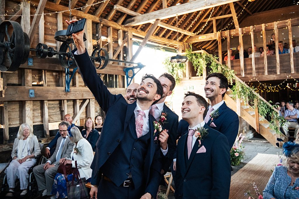 Multi coloured Summer wedding with a bride wearing green at The Barns at Lodge Farm. Essex documentary wedding photographer