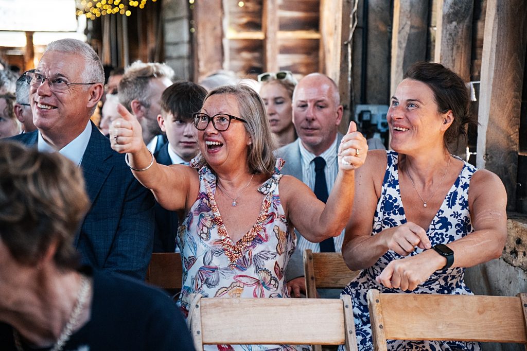 Multi coloured Summer wedding with a bride wearing green at The Barns at Lodge Farm. Essex documentary wedding photographer