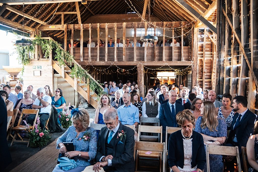 Multi coloured Summer wedding with a bride wearing green at The Barns at Lodge Farm. Essex documentary wedding photographer