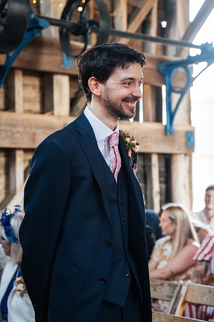 Multi coloured Summer wedding with a bride wearing green at The Barns at Lodge Farm. Essex documentary wedding photographer