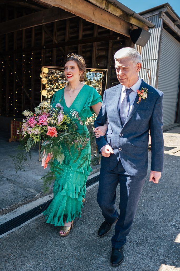 Multi coloured Summer wedding with a bride wearing green at The Barns at Lodge Farm. Essex documentary wedding photographer
