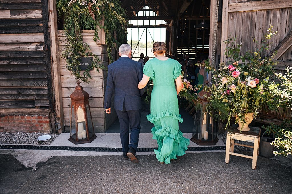 Multi coloured Summer wedding with a bride wearing green at The Barns at Lodge Farm. Essex documentary wedding photographer