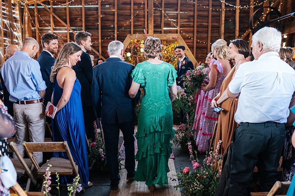Multi coloured Summer wedding with a bride wearing green at The Barns at Lodge Farm. Essex documentary wedding photographer