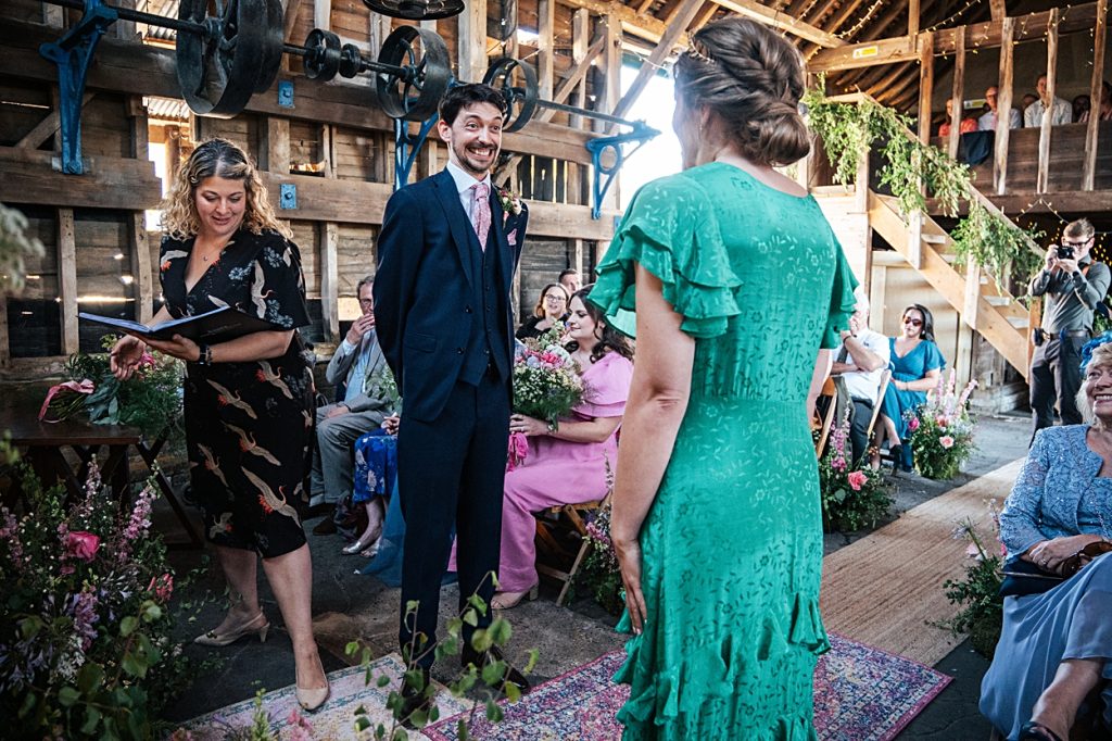 Multi coloured Summer wedding with a bride wearing green at The Barns at Lodge Farm. Essex documentary wedding photographer