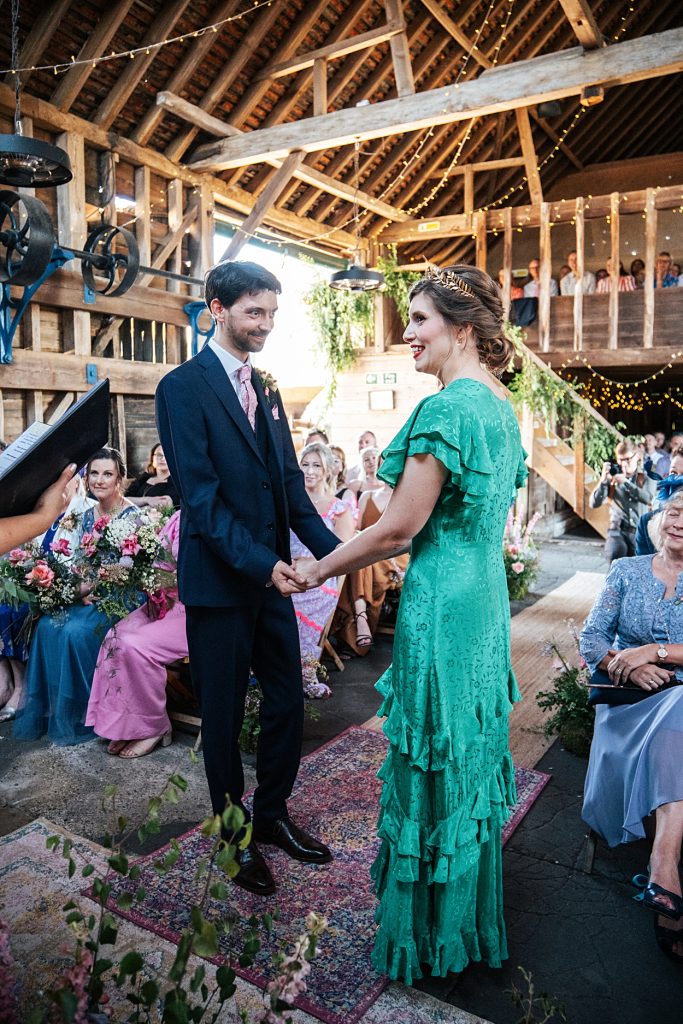 Multi coloured Summer wedding with a bride wearing green at The Barns at Lodge Farm. Essex documentary wedding photographer