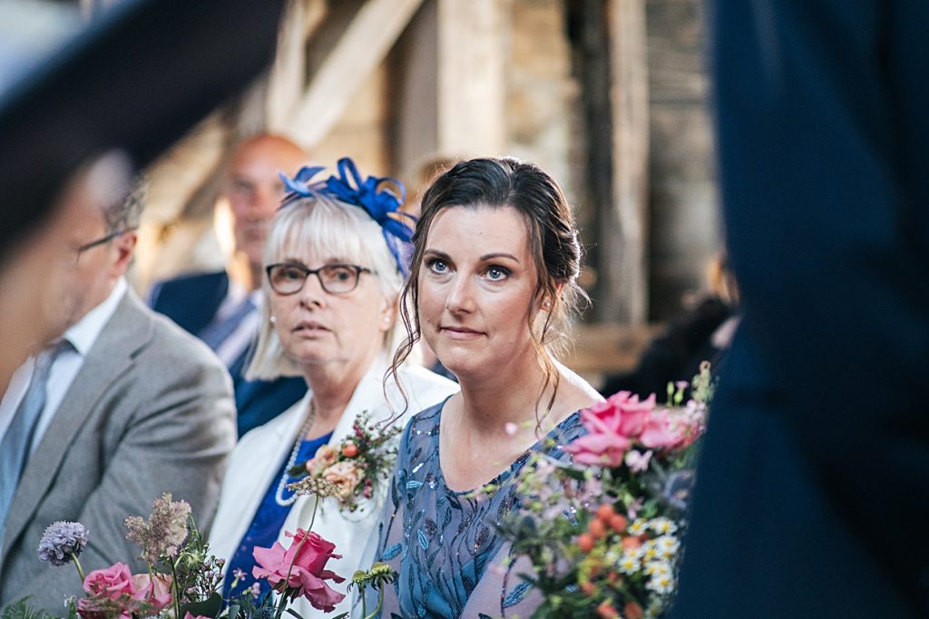 Multi coloured Summer wedding with a bride wearing green at The Barns at Lodge Farm. Essex documentary wedding photographer