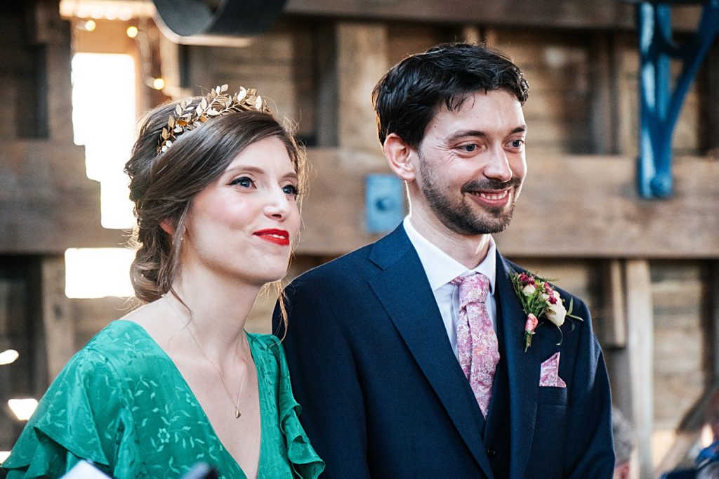 Multi coloured Summer wedding with a bride wearing green at The Barns at Lodge Farm. Essex documentary wedding photographer