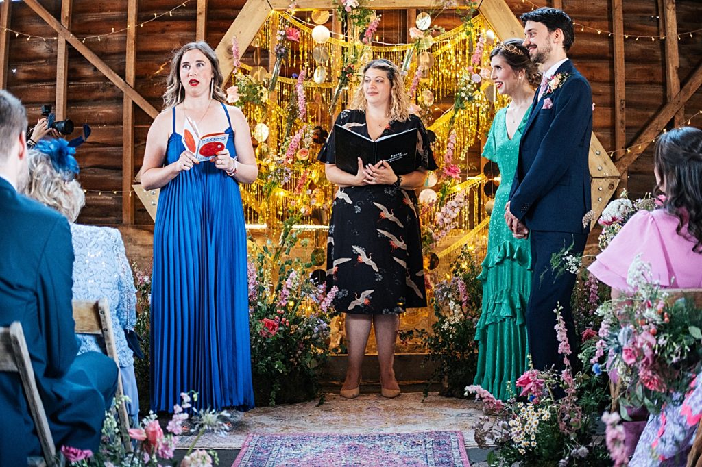 Multi coloured Summer wedding with a bride wearing green at The Barns at Lodge Farm. Essex documentary wedding photographer