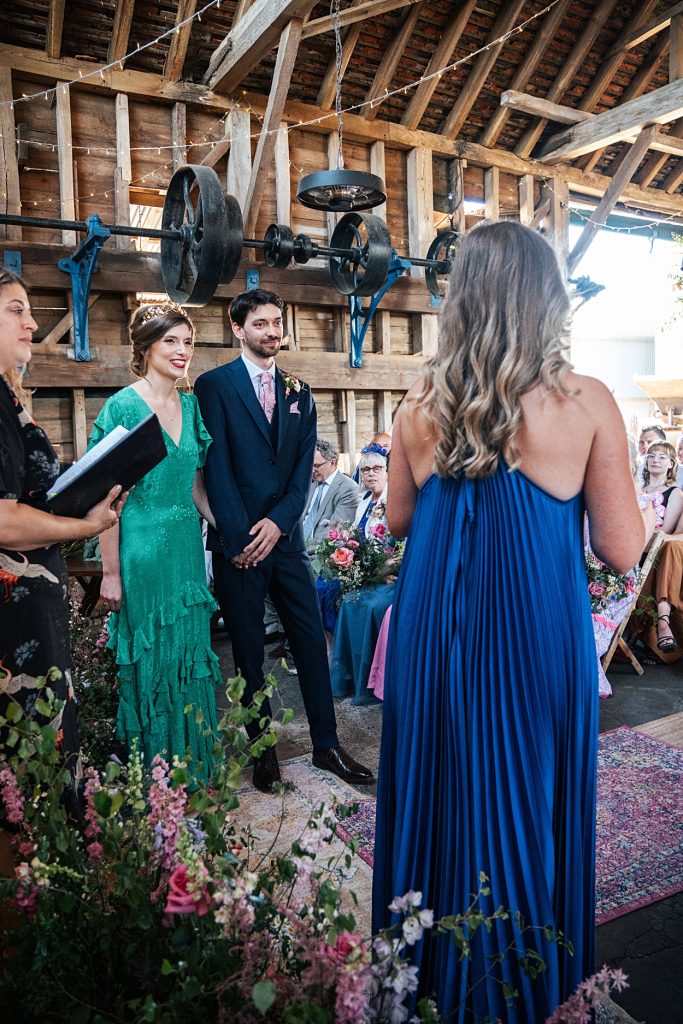 Multi coloured Summer wedding with a bride wearing green at The Barns at Lodge Farm. Essex documentary wedding photographer