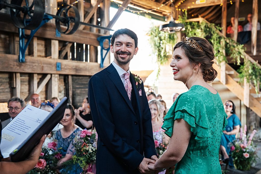 Multi coloured Summer wedding with a bride wearing green at The Barns at Lodge Farm. Essex documentary wedding photographer