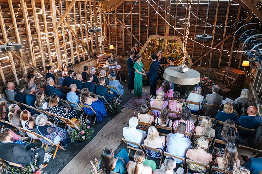 Multi coloured Summer wedding with a bride wearing green at The Barns at Lodge Farm. Essex documentary wedding photographer