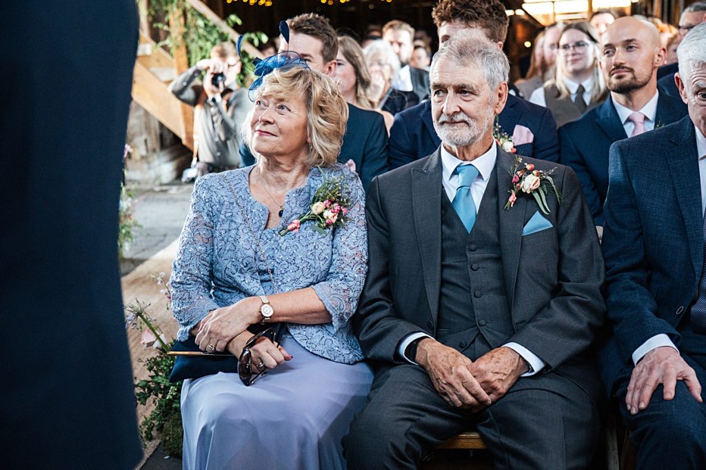 Multi coloured Summer wedding with a bride wearing green at The Barns at Lodge Farm. Essex documentary wedding photographer