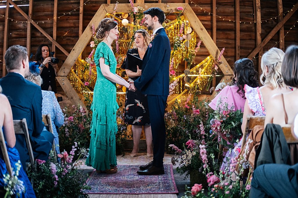 Multi coloured Summer wedding with a bride wearing green at The Barns at Lodge Farm. Essex documentary wedding photographer