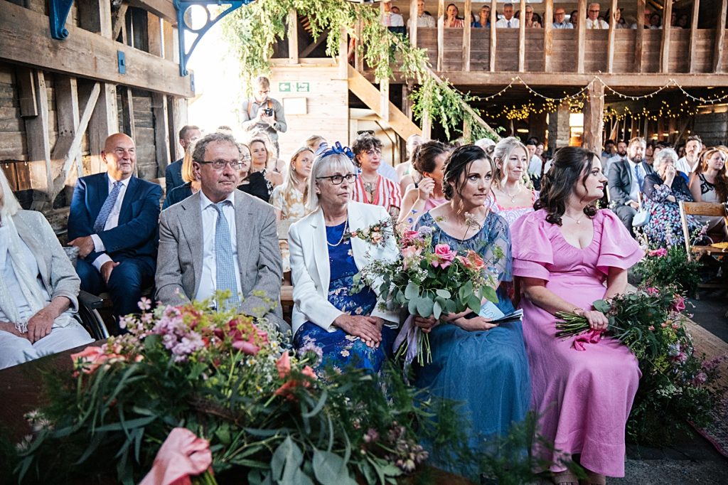 Multi coloured Summer wedding with a bride wearing green at The Barns at Lodge Farm. Essex documentary wedding photographer