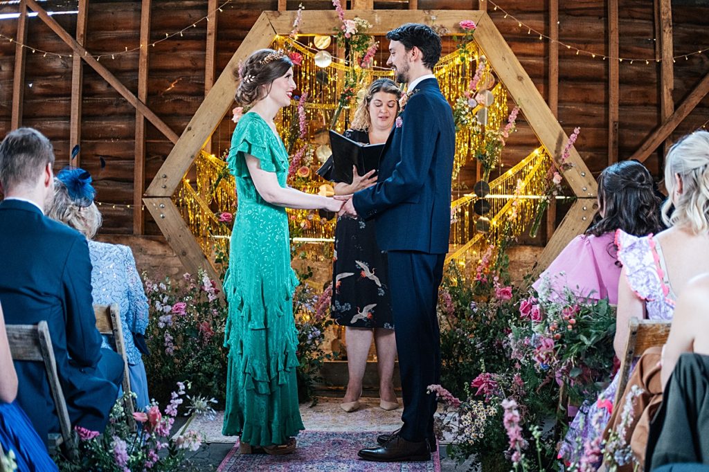 Multi coloured Summer wedding with a bride wearing green at The Barns at Lodge Farm. Essex documentary wedding photographer