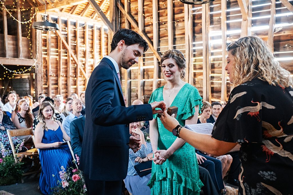 Multi coloured Summer wedding with a bride wearing green at The Barns at Lodge Farm. Essex documentary wedding photographer