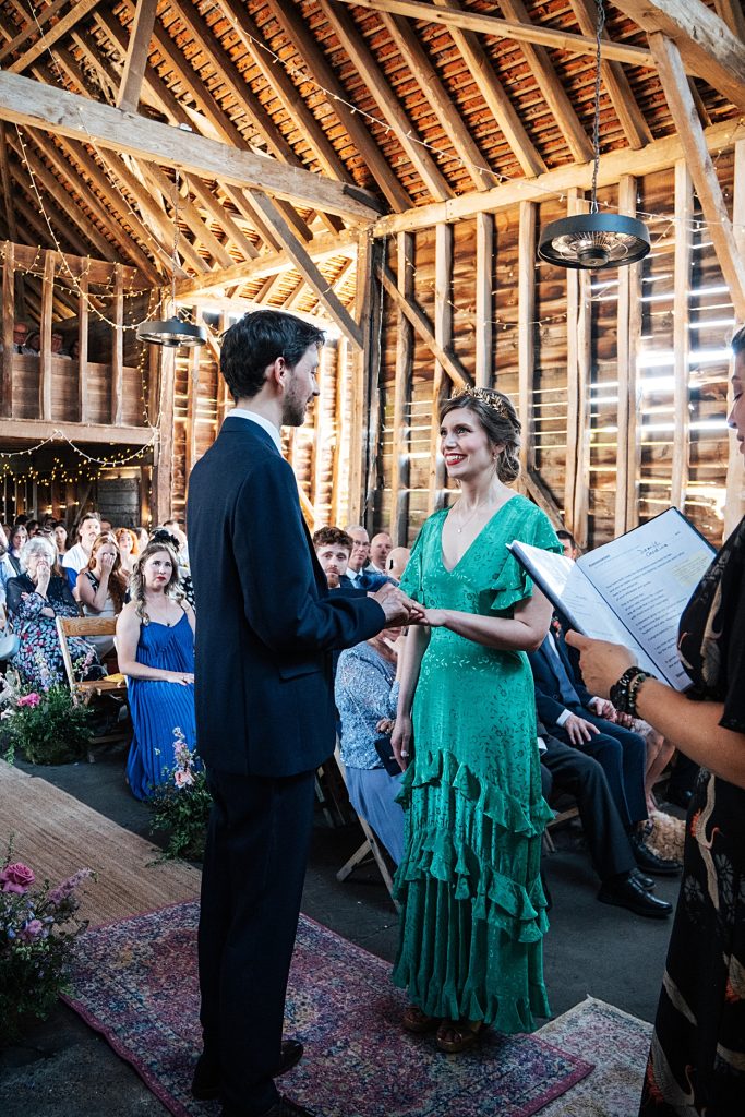 Multi coloured Summer wedding with a bride wearing green at The Barns at Lodge Farm. Essex documentary wedding photographer