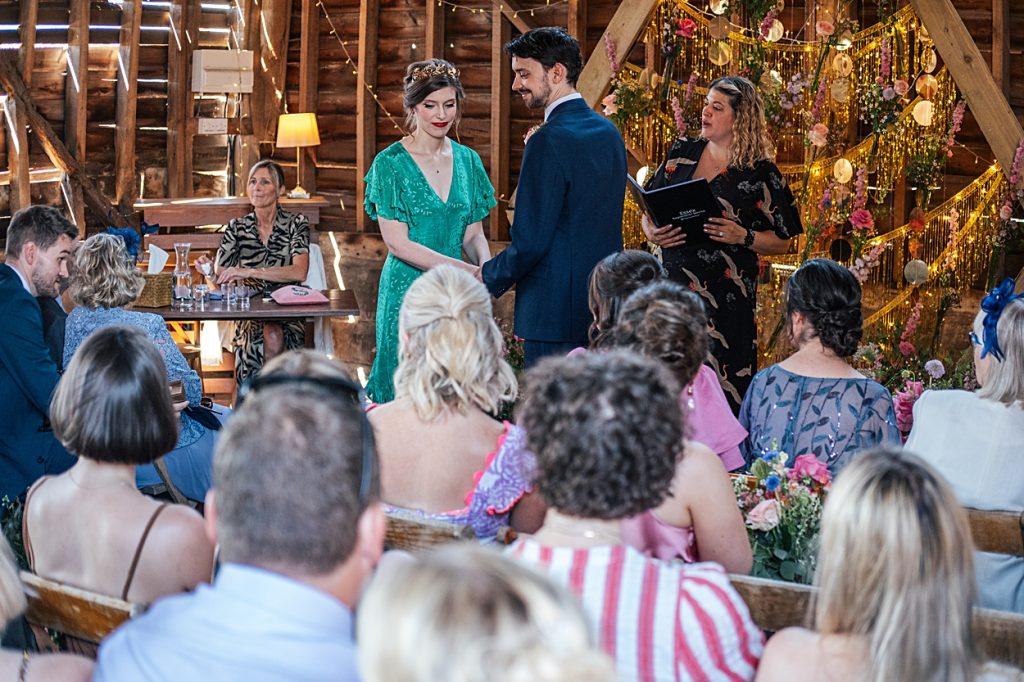 Multi coloured Summer wedding with a bride wearing green at The Barns at Lodge Farm. Essex documentary wedding photographer