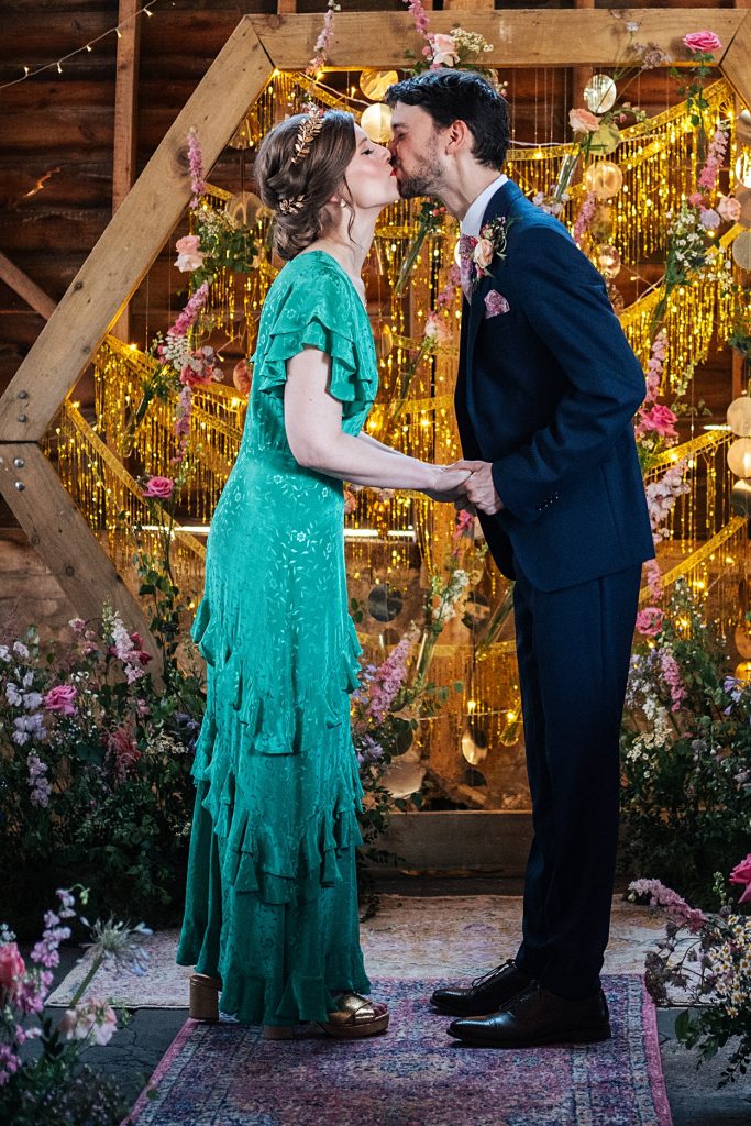 Multi coloured Summer wedding with a bride wearing green at The Barns at Lodge Farm. Essex documentary wedding photographer