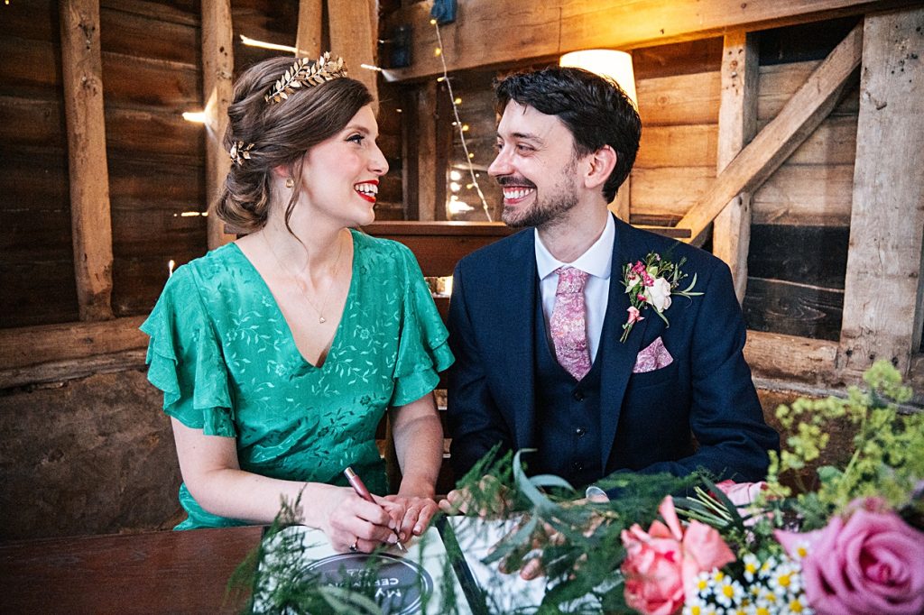 Multi coloured Summer wedding with a bride wearing green at The Barns at Lodge Farm. Essex documentary wedding photographer