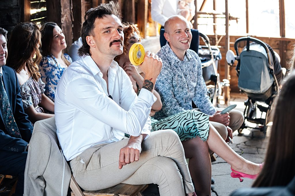 Multi coloured Summer wedding with a bride wearing green at The Barns at Lodge Farm. Essex documentary wedding photographer