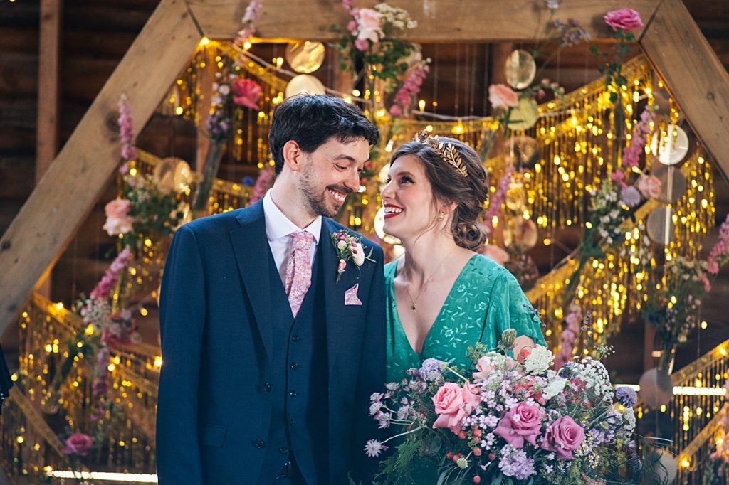 Multi coloured Summer wedding with a bride wearing green at The Barns at Lodge Farm. Essex documentary wedding photographer
