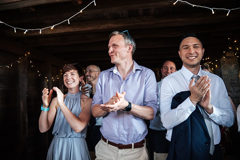 Multi coloured Summer wedding with a bride wearing green at The Barns at Lodge Farm. Essex documentary wedding photographer
