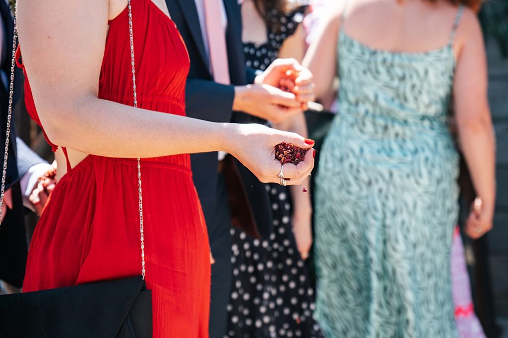 Multi coloured Summer wedding with a bride wearing green at The Barns at Lodge Farm. Essex documentary wedding photographer