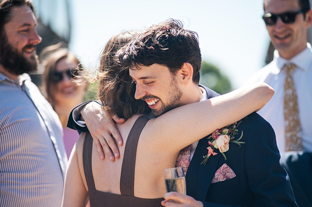 Multi coloured Summer wedding with a bride wearing green at The Barns at Lodge Farm. Essex documentary wedding photographer