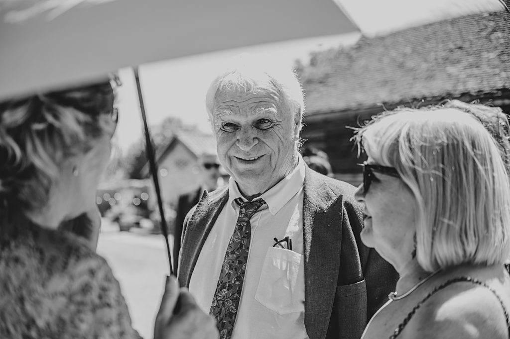 Multi coloured Summer wedding with a bride wearing green at The Barns at Lodge Farm. Essex documentary wedding photographer