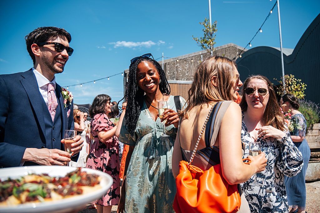 Multi coloured Summer wedding with a bride wearing green at The Barns at Lodge Farm. Essex documentary wedding photographer