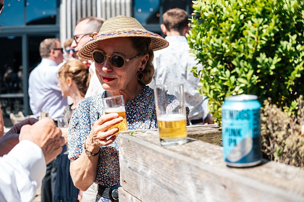 Multi coloured Summer wedding with a bride wearing green at The Barns at Lodge Farm. Essex documentary wedding photographer
