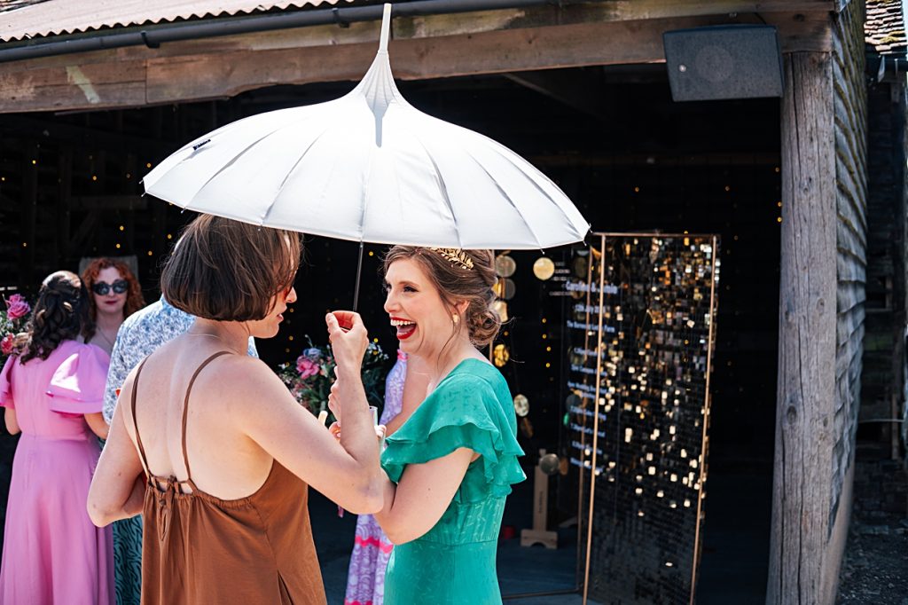 Multi coloured Summer wedding with a bride wearing green at The Barns at Lodge Farm. Essex documentary wedding photographer