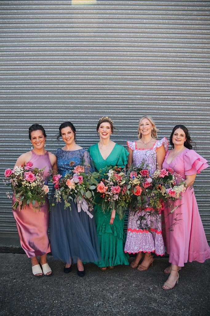 Multi coloured Summer wedding with a bride wearing green at The Barns at Lodge Farm. Essex documentary wedding photographer
