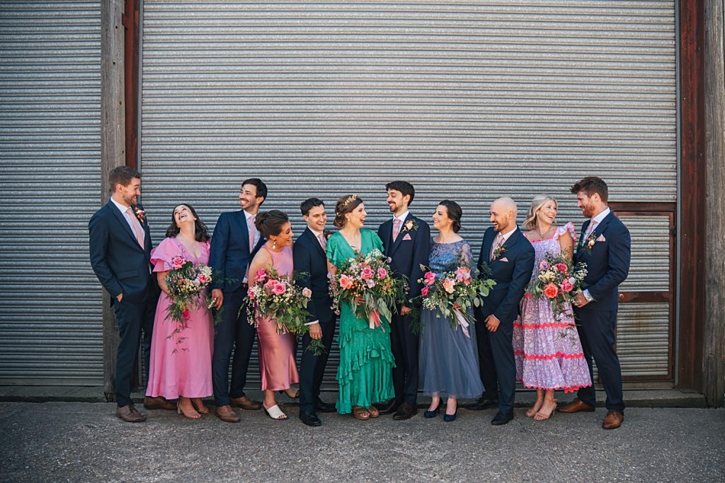 Multi coloured Summer wedding with a bride wearing green at The Barns at Lodge Farm. Essex documentary wedding photographer