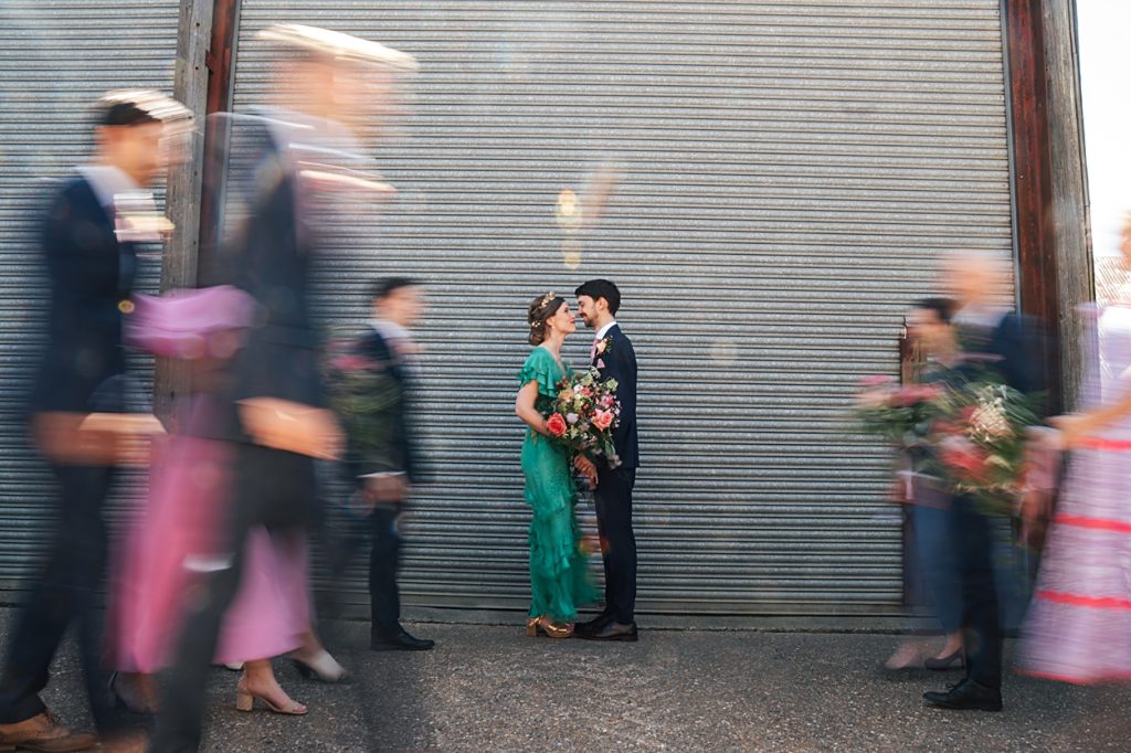 Multi coloured Summer wedding with a bride wearing green at The Barns at Lodge Farm. Essex documentary wedding photographer