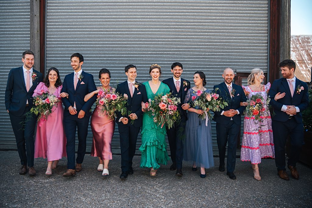 Multi coloured Summer wedding with a bride wearing green at The Barns at Lodge Farm. Essex documentary wedding photographer