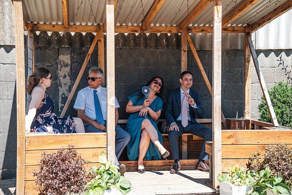 Multi coloured Summer wedding with a bride wearing green at The Barns at Lodge Farm. Essex documentary wedding photographer
