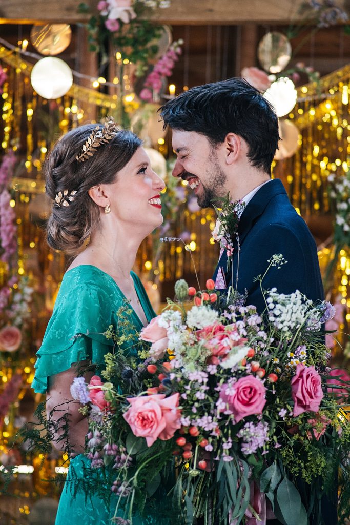 Multi coloured Summer wedding with a bride wearing green at The Barns at Lodge Farm. Essex documentary wedding photographer