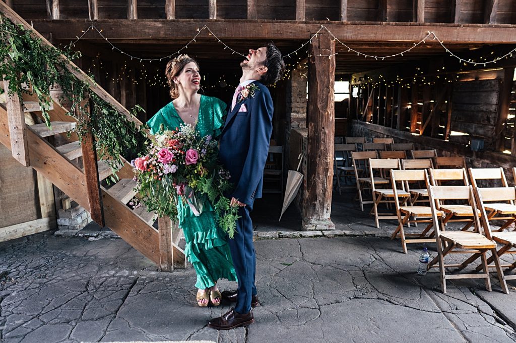 Multi coloured Summer wedding with a bride wearing green at The Barns at Lodge Farm. Essex documentary wedding photographer