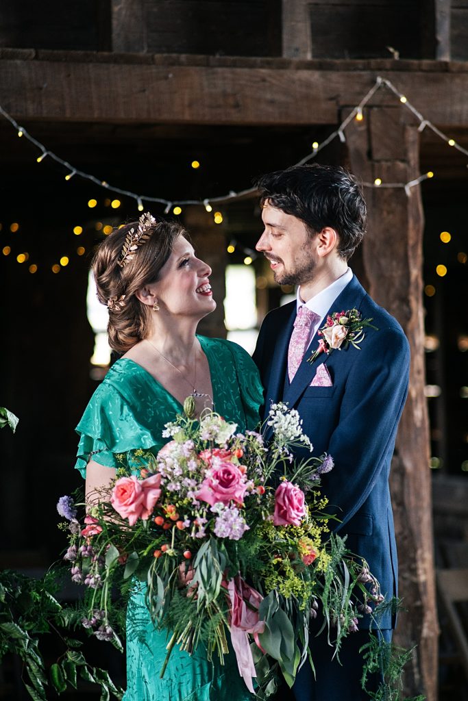 Multi coloured Summer wedding with a bride wearing green at The Barns at Lodge Farm. Essex documentary wedding photographer