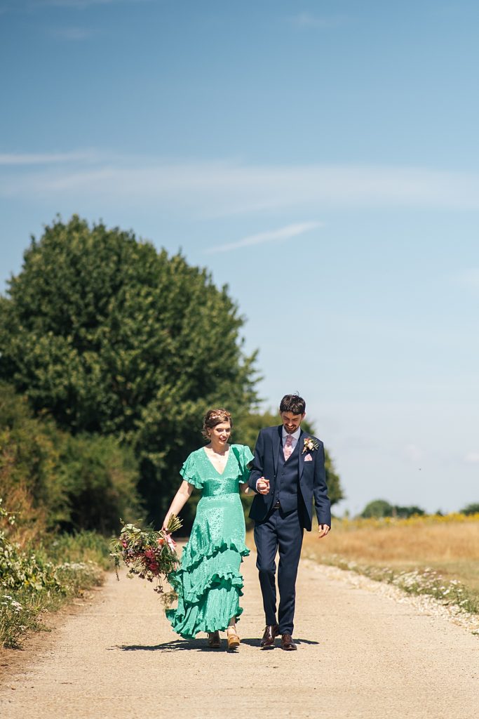 Multi coloured Summer wedding with a bride wearing green at The Barns at Lodge Farm. Essex documentary wedding photographer
