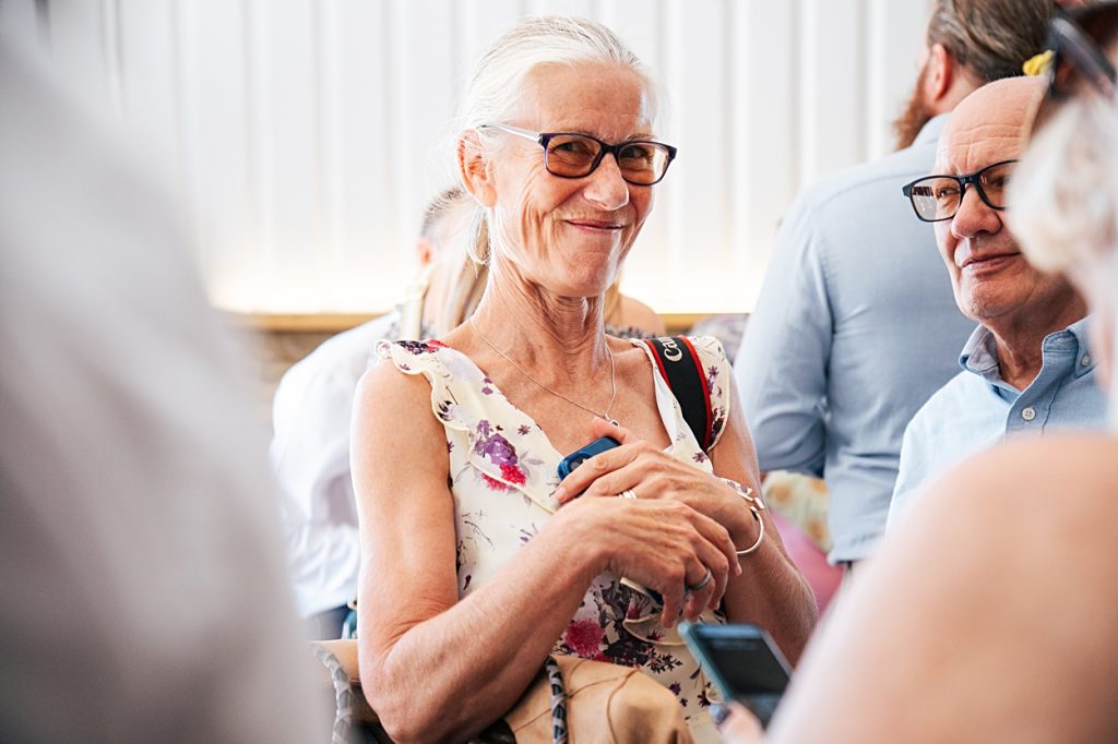 Multi coloured Summer wedding with a bride wearing green at The Barns at Lodge Farm. Essex documentary wedding photographer