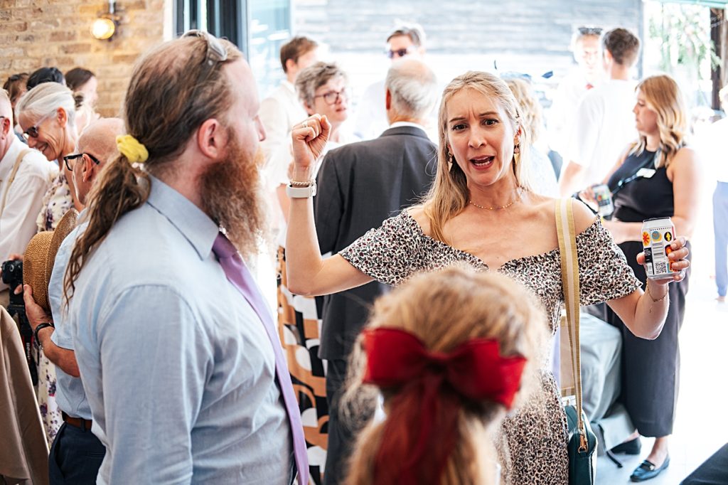 Multi coloured Summer wedding with a bride wearing green at The Barns at Lodge Farm. Essex documentary wedding photographer
