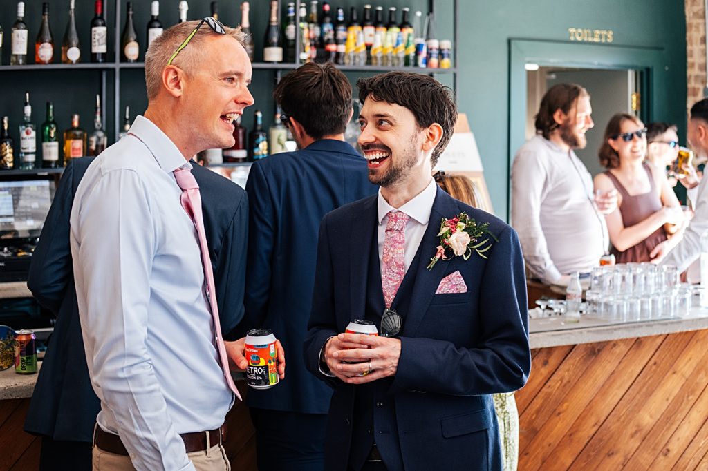 Multi coloured Summer wedding with a bride wearing green at The Barns at Lodge Farm. Essex documentary wedding photographer