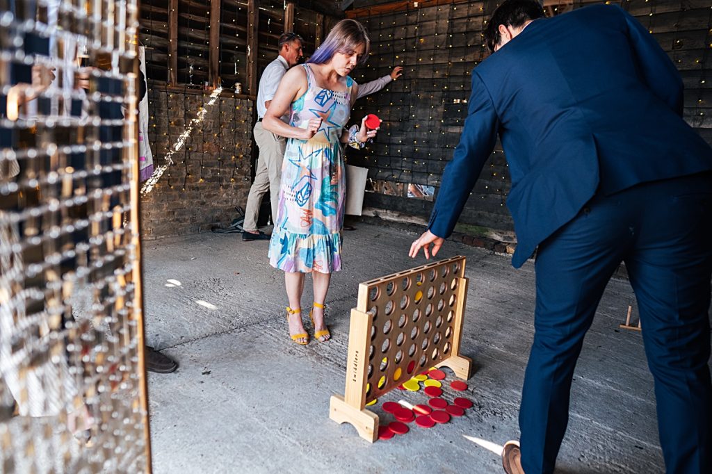 Multi coloured Summer wedding with a bride wearing green at The Barns at Lodge Farm. Essex documentary wedding photographer