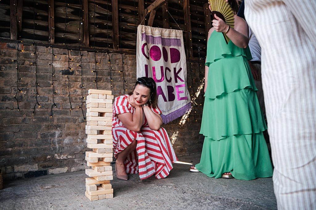 Multi coloured Summer wedding with a bride wearing green at The Barns at Lodge Farm. Essex documentary wedding photographer
